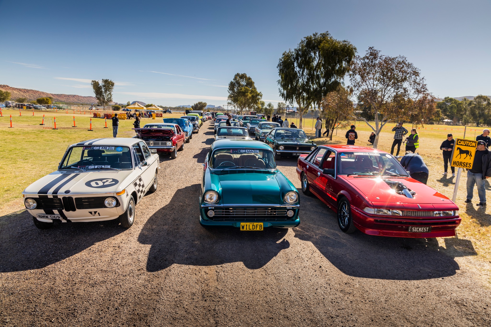 Cars driving together on a scenic road, representing Konvoy app's connected driving experience